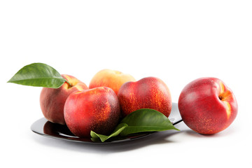 Fresh peaches and nectarines in a basket isolated on a white bac