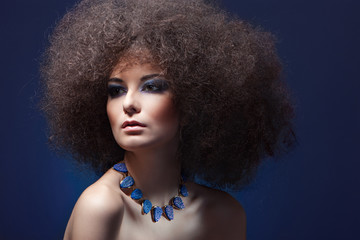 beauty woman with curly hair and blue make-up