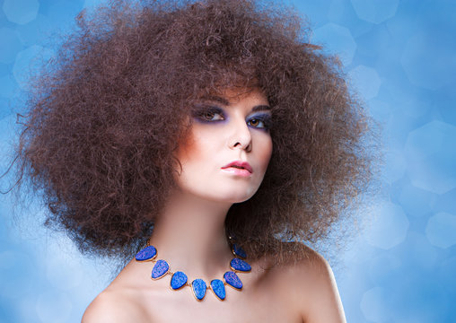 curly hair and blue make-up