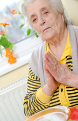 Senior woman folded her hands in prayer