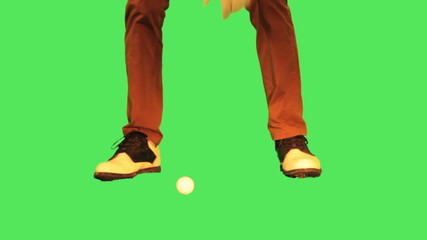 male placing golf ball and putting