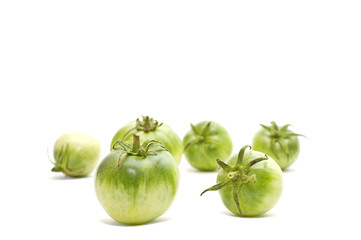 Green tomatoes on a white background