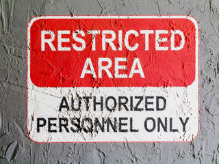 Restricted area sign painted on wall