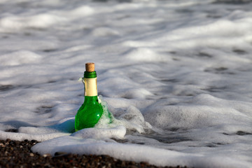 Bottle of wine in sea surf