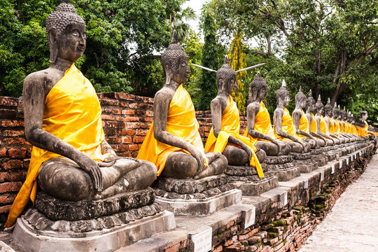 Stone Buddha statue in row
