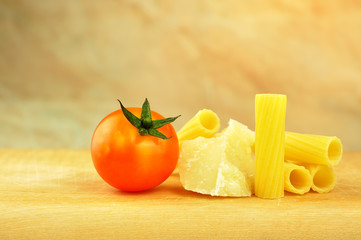 Raw tortiglioni pasta with parmesan and cherry tomato