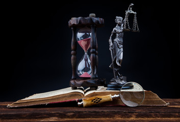 old book and temida statue
