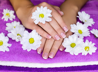 Obraz na płótnie Canvas Hands on towels with flowers