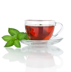 Cup of tea with mint leaves isolated on white background