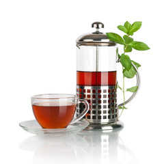 Cup with tea and teapot, isolated on white