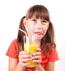 Little girl with a big glass of juice