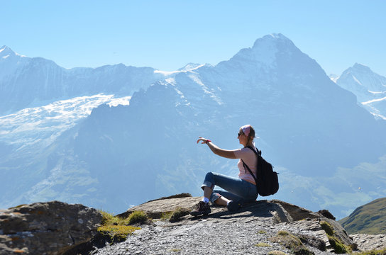 Traveler on the top of a rock. Jungfrau region, Switzerland