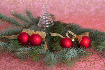 Four red Christmas balls on spruce branches