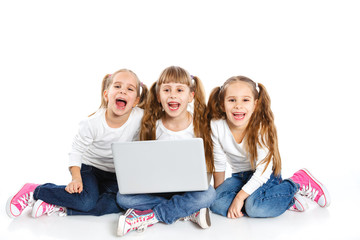 Three attractive girl using a laptop