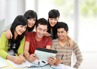 Friendly group of students using tablet pc