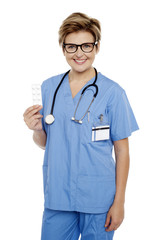 Doctor at duty holding medicine pack in hand