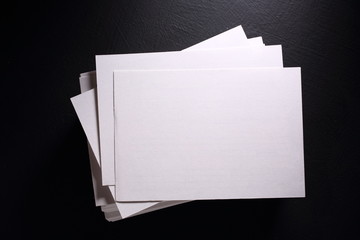 Stack of white paper cards on black