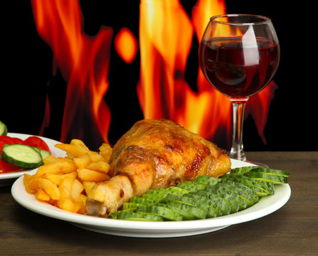 Roast chicken with french fries and cucumbers, glass of wine