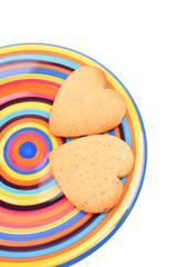 biscuits on colourful dish, isolated on white background