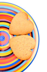 biscuits on colourful dish, isolated on white background