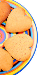 biscuits on colourful dish, isolated on white background