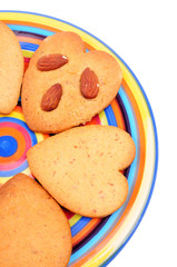 biscuits on colourful dish, isolated on white background