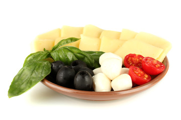 sliced mozzarella cheese with vegetables in the plate isolated
