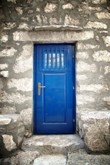 Fototapeta na wymiar Blue door in old stone house