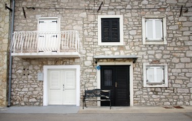 Old stone house with shutters in front view