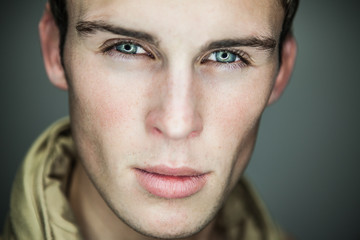 Closeup portrait of sensual man with beautiful face and eyes.