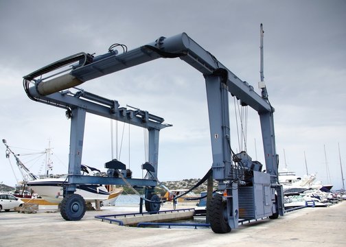 Crane to lifting boats at harbor, marina