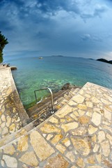 Beach and clear sea with clouds, Croatia Dalmatia