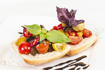 juicy tomatoes on fresh bread, pesto as topping