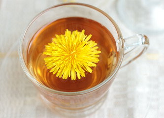 tea in glass cup and flowers