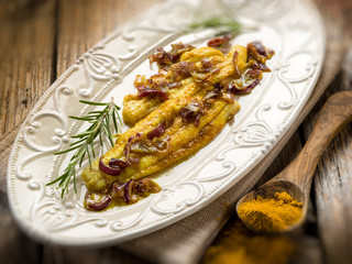 sole fish with curry and onions, selective focus