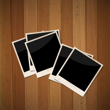 Photo frames on wooden background