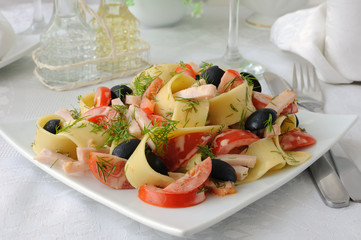Pasta salad with ham, tomato and olives