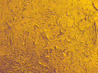 texture of old wall with a  cracked golden paint.