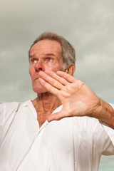 Fototapeta premium Senior spiritual man dressed in white.Exercising outdoors.