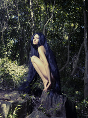 Beautiful nude lady in the rainforest
