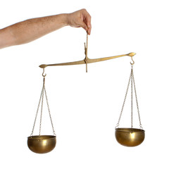 Hand holding bronze balance