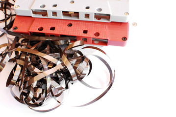 Magnetic tape and earphone on white background