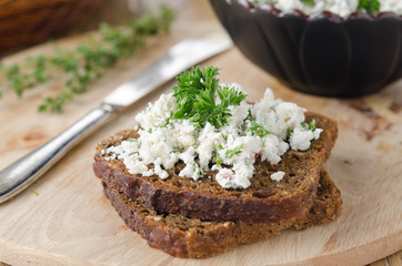 pate of cottage cheese with herbs and chili peppers on a piece o