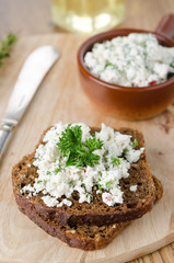 pate of cottage cheese with herbs and chili peppers on a piece o