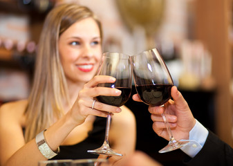 Couple toasting red wine