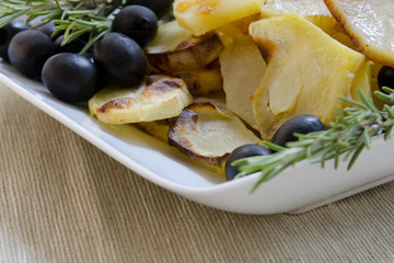 Roasted potatoes with herbs in bowl. Selective focus