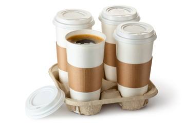 Four take-out coffee in holder. One cup is opened. - 46574802