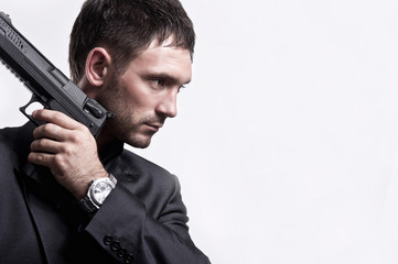 ortrait Of Young Man With Gun On White Background