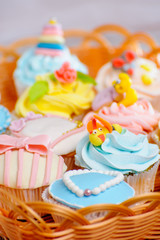 many delicious colorful cupcakes in a basket