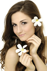 Obraz na płótnie Canvas Beautiful Spa Girl face with frangipani